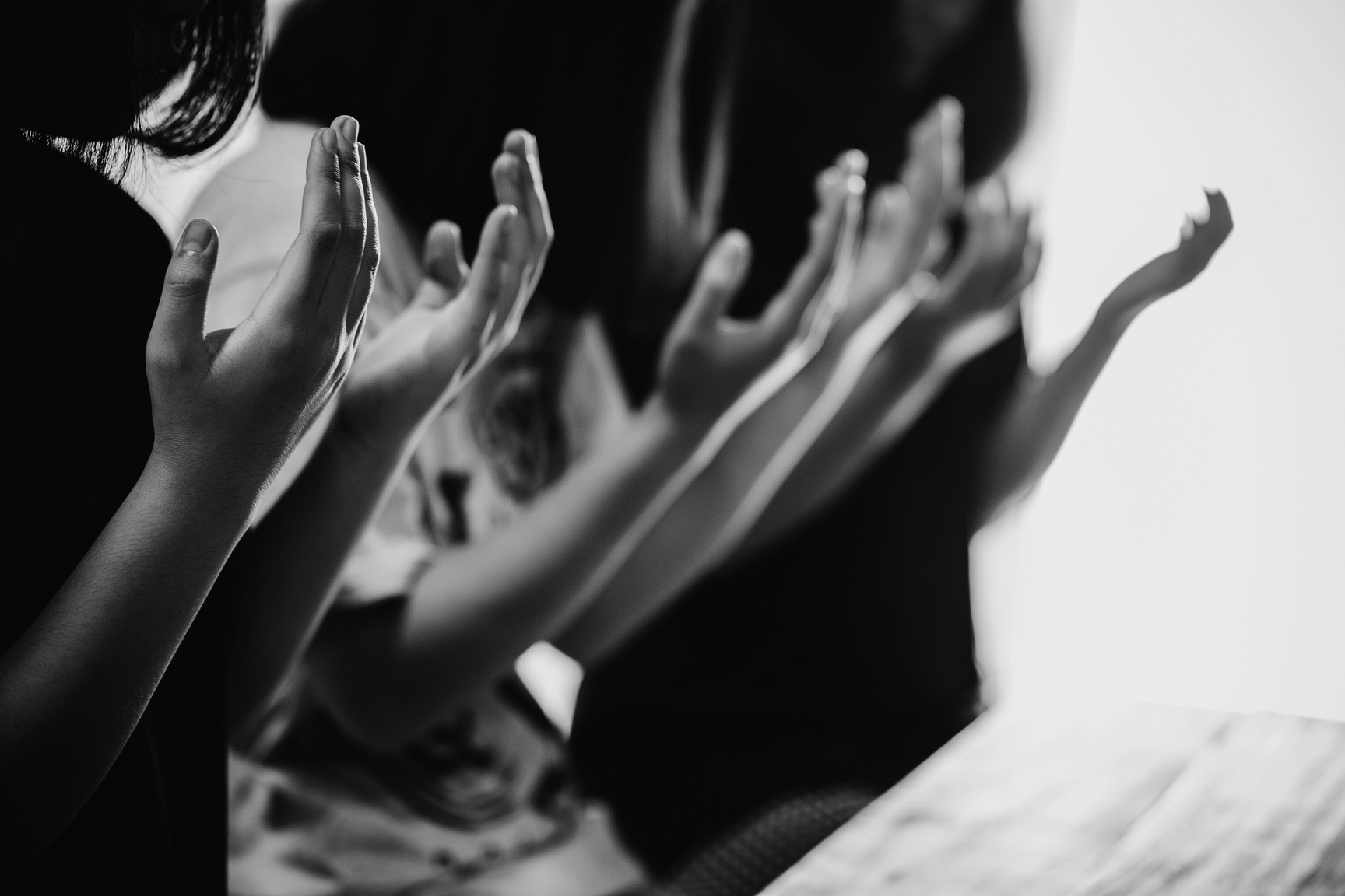 Black and White Photo of People Praying Together 